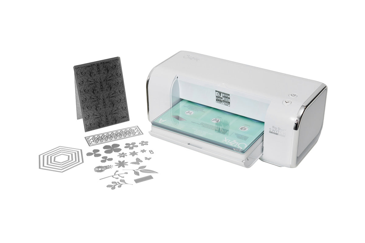 Manufacturer photograph of the white Sizzix Big Shot Switch Plus electric machine and starter accessories